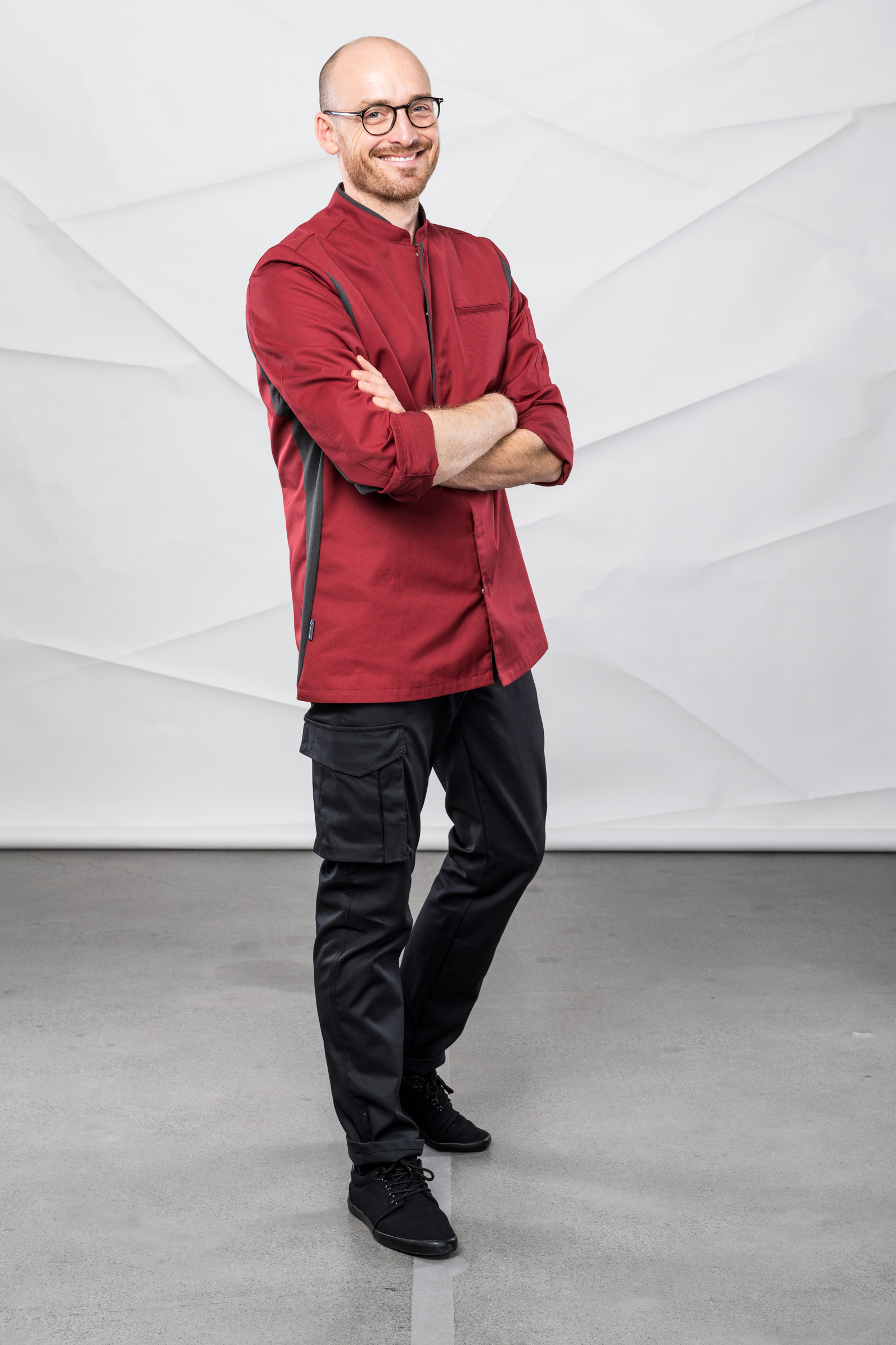 Mann in Servicejacke und Hose im Lebensmitteleinzelhandel